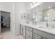 Bathroom featuring double sinks, gray cabinets, white countertops, and ample storage at 921 Fieldstone Way, Haines City, FL 33844