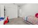 Bedroom features a bed with patterned bedding, work space area with a red desk chair, and a large closet at 921 Fieldstone Way, Haines City, FL 33844