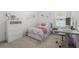 Bedroom with stylish decor, comfortable bed, study desk and a dresser, perfect for relaxation and productivity at 921 Fieldstone Way, Haines City, FL 33844