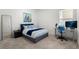 Bedroom features a comfortable bed, modern desk setup, and soft natural light, creating a serene and productive space at 921 Fieldstone Way, Haines City, FL 33844