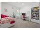 Bright bedroom featuring carpet floors, ample natural light and a cozy study corner with a desk and chair at 921 Fieldstone Way, Haines City, FL 33844