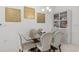 Dining area with a glass table, six chairs, modern lighting fixture and beautiful art hanging on the wall at 921 Fieldstone Way, Haines City, FL 33844
