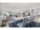 Bright open concept dining area with sleek marble table and plush chairs next to the kitchen and living room at 921 Fieldstone Way, Haines City, FL 33844