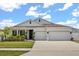 Charming single-story home showcasing a well-manicured lawn and a spacious three-car garage at 921 Fieldstone Way, Haines City, FL 33844
