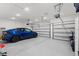 Spacious three car garage with epoxy flooring and a blue car at 921 Fieldstone Way, Haines City, FL 33844