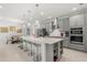 Contemporary kitchen features a large center island with seating and modern appliances at 921 Fieldstone Way, Haines City, FL 33844