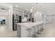 Kitchen boasts a large white quartz island, stainless steel appliances, pendant lighting and gray cabinets at 921 Fieldstone Way, Haines City, FL 33844
