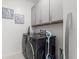 Laundry room featuring modern washer and dryer, storage cabinets, and decor at 921 Fieldstone Way, Haines City, FL 33844