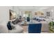 Open concept living space features modern decor and comfortable seating flowing to the dining area at 921 Fieldstone Way, Haines City, FL 33844