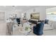 Bright and airy living area featuring comfortable seating and a view into the dining space at 921 Fieldstone Way, Haines City, FL 33844