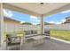 Covered patio with modern outdoor seating, perfect for relaxation and entertaining at 921 Fieldstone Way, Haines City, FL 33844