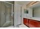 Bathroom featuring a glass-enclosed shower and a double vanity at 3002 Sunscape Ter, Groveland, FL 34736