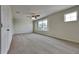 Spacious bedroom featuring neutral carpeting, a ceiling fan, and a large window for natural light at 3002 Sunscape Ter, Groveland, FL 34736