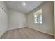 Cozy bedroom featuring carpeted floors, a closet, and a window at 3002 Sunscape Ter, Groveland, FL 34736