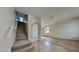Inviting entryway with tile flooring, staircase, and arched doorway to the living area at 3002 Sunscape Ter, Groveland, FL 34736