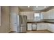 Modern kitchen with stainless steel appliances and white cabinets at 3002 Sunscape Ter, Groveland, FL 34736