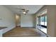 Spacious living room with hardwood floors and glass sliding door at 3002 Sunscape Ter, Groveland, FL 34736