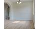 Bright living room with hardwood floors, chandelier, and large windows at 3002 Sunscape Ter, Groveland, FL 34736