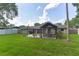Expansive backyard with a lush lawn, a basketball hoop, and a gazebo for outdoor enjoyment at 781 Little Pine Dr, South Daytona, FL 32119