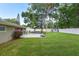 Lush backyard with ample green space, a basketball area, a gazebo, and a storage shed at 781 Little Pine Dr, South Daytona, FL 32119