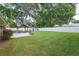 Well-maintained backyard featuring a spacious lawn, a gazebo with seating, and a tidy storage shed at 781 Little Pine Dr, South Daytona, FL 32119