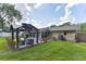 Spacious backyard featuring a covered patio area with outdoor furniture, perfect for entertaining at 781 Little Pine Dr, South Daytona, FL 32119
