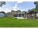 Large backyard with a well-manicured lawn, a basketball hoop, and a shaded gazebo area at 781 Little Pine Dr, South Daytona, FL 32119