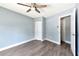 Neutral bedroom with an overhead fan, two doors, and gray wood floors at 781 Little Pine Dr, South Daytona, FL 32119