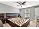 Bedroom with a large bed frame, wood floors, and neutral colors, creating a relaxing atmosphere at 781 Little Pine Dr, South Daytona, FL 32119