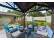 Inviting gazebo with cozy seating, perfect for outdoor gatherings in a landscaped backyard at 781 Little Pine Dr, South Daytona, FL 32119