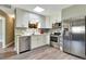 Modern kitchen with stainless steel appliances, white cabinets, light countertops, and stylish backsplash detailing at 781 Little Pine Dr, South Daytona, FL 32119
