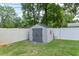 A backyard shed with double doors nestled within a fenced yard, offering outdoor storage at 781 Little Pine Dr, South Daytona, FL 32119