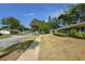 Residential street scene showcasing a well-kept lawn and a charming home with a manicured front yard and palm tree at 781 Little Pine Dr, South Daytona, FL 32119