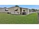Spacious backyard with lush green grass and home exterior, providing ample outdoor space at 1610 Reynolds Rd # 5, Lakeland, FL 33801