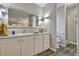 Well-lit bathroom featuring modern vanity with storage, large mirror, and separate toilet and shower area at 1610 Reynolds Rd # 5, Lakeland, FL 33801