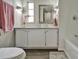 Bright bathroom with vanity storage, decorative mirror, and a tub, offering style and functionality at 1610 Reynolds Rd # 5, Lakeland, FL 33801