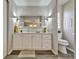 Bright bathroom features modern vanity, large mirror with decorative sconces, and convenient toilet area at 1610 Reynolds Rd # 5, Lakeland, FL 33801