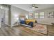 Inviting bedroom with wood-look flooring, neutral walls, and a comfortable bed with accent pillows at 1610 Reynolds Rd # 5, Lakeland, FL 33801