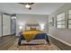 Stylishly decorated bedroom featuring a comfortable bed with a colorful rug and modern ceiling fan at 1610 Reynolds Rd # 5, Lakeland, FL 33801