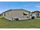 Cozy, one story home featuring vinyl siding, a small awning, and well-maintained lawn at 1610 Reynolds Rd # 5, Lakeland, FL 33801