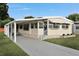 Well-maintained single-story home with a covered carport and lush green lawn at 1610 Reynolds Rd # 5, Lakeland, FL 33801