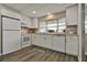 Bright kitchen with white appliances, modern cabinets, and a window over the sink at 1610 Reynolds Rd # 5, Lakeland, FL 33801