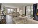 Comfortable living room with modern furniture, sliding glass doors and view to the dining area at 1610 Reynolds Rd # 5, Lakeland, FL 33801