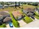 Aerial view showcasing a well-maintained house with a lush green lawn, driveway, and surrounding neighborhood at 358 Canna Dr, Davenport, FL 33897