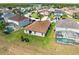 Overhead image of a home with a large backyard, screened-in pools, and suburban neighborhood at 358 Canna Dr, Davenport, FL 33897