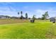 Spacious backyard on a sloped lot with a trampoline, lush grass, and neighborhood views at 358 Canna Dr, Davenport, FL 33897