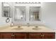 Bathroom with double vanity and a pair of framed mirrors at 358 Canna Dr, Davenport, FL 33897