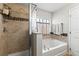 A bathroom featuring a walk in shower and separate soaking tub at 358 Canna Dr, Davenport, FL 33897
