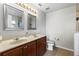 Bathroom boasts dual sinks, framed mirrors, vanity lighting, and neutral color scheme at 358 Canna Dr, Davenport, FL 33897