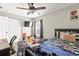 Bedroom featuring closet, window, ceiling fan, and bedroom furniture at 358 Canna Dr, Davenport, FL 33897